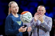 Dallas Wings guard Paige Bueckers is presented with a ball commemorating her being voted a...