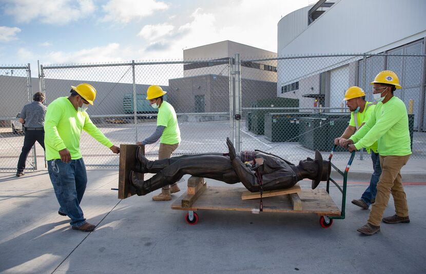 A Phoenix 1 Restoration & Construction crew wheeled out the "One Riot, One Ranger" statue...