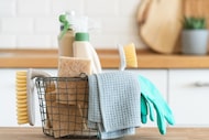 Basket of cleaning supplies on a kitchen counter