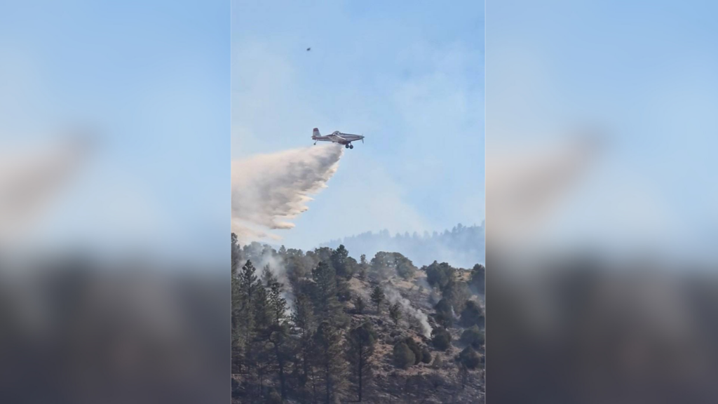 An airplane drops retardant on a wildfire in Costilla County. (Courtesy of Costilla County OEM).