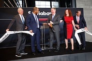 Scotiabank President and CEO Scott Thomson, third from left, reacts after cutting a ribbon...