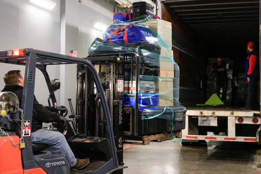 Scott Studebaker, Perimeter Global Logistics project manager, drives a fork lift with Texas...