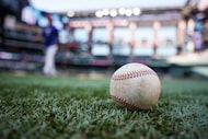 A ball rests in foul territory at the Texas Rangers take batting practice before an...