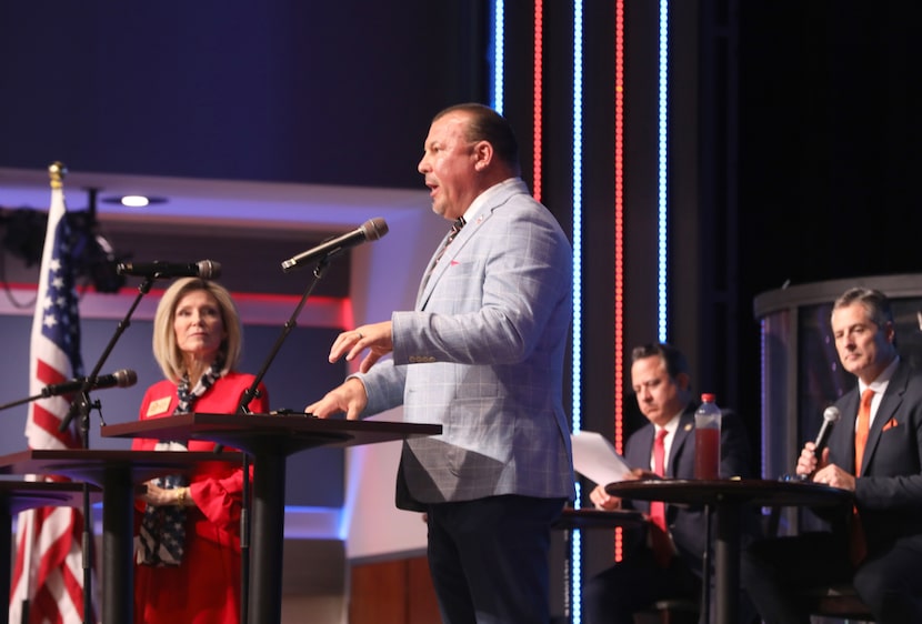 Frederick Frazier speaks as Rep. Keresa Richardson looks on during a candidate forum for...