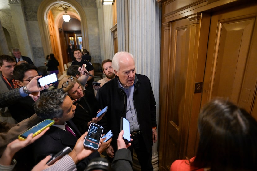 Sen. John Cornyn, R-Texas, talks with reporters as he leaves the Senate chamber during a...