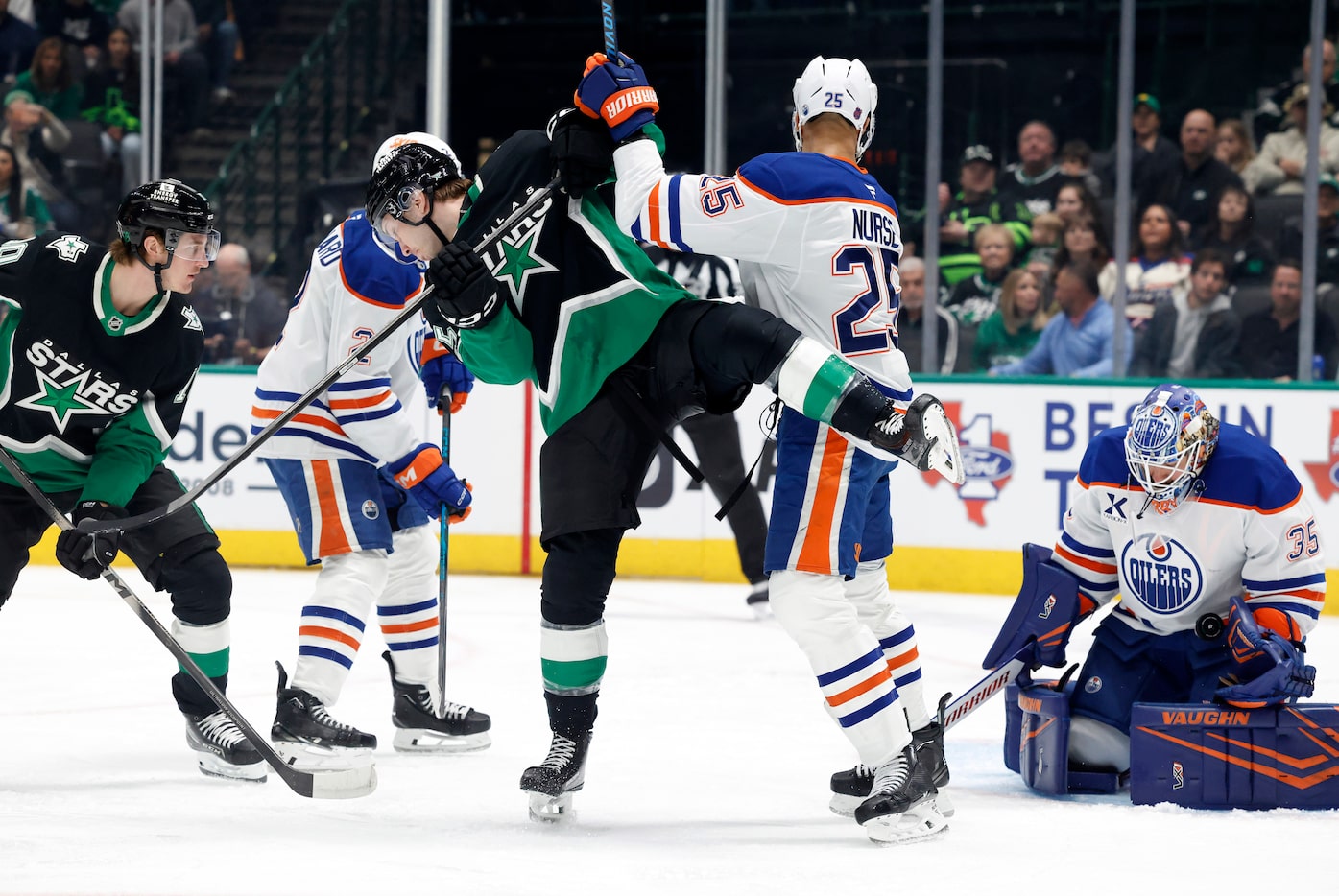 Dallas Stars right wing Arttu Hyry (25) is tipped by Edmonton Oilers defenseman Darnell...