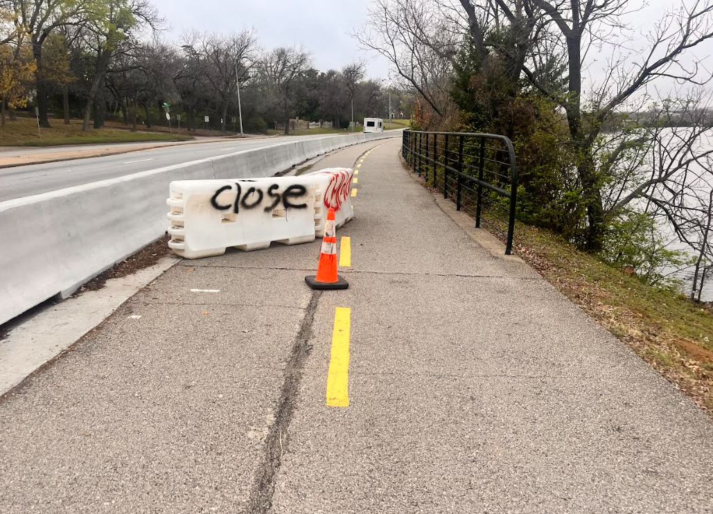 A traffic barrier partially blocking the trail Monday morning.