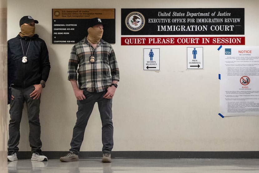 Federal agents stand outside immigration court at the Jacob K. Javits federal building in...