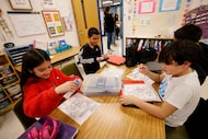 Third grader Aleah Zamora, clockwise from left, adds color to the flier about the solar...