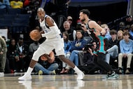 Dallas Mavericks forward Khris Middleton, left, handles the ball against Memphis Grizzlies...