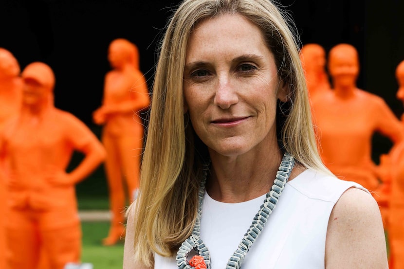 Nicole Small, CEO of LH Capital Inc., surrounded by 121 sculptures, all of women in STEM as...