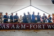 Texas A&M University System, Fort Worth and business leaders toss dirt at a groundbreaking...