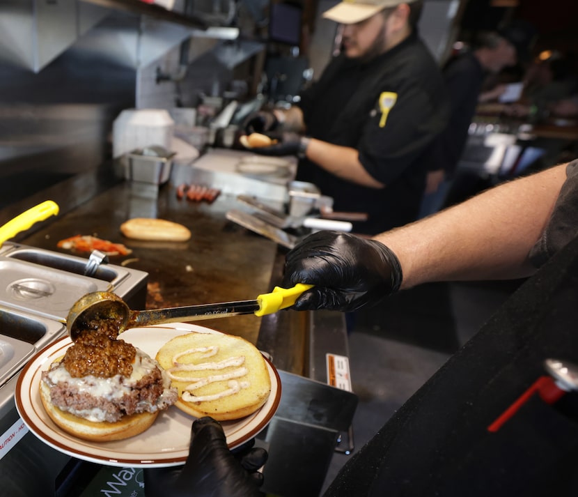 Chili is added to a burger at Shorty's Coneys and Cocktails in McKinney.
