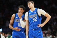 Dallas Mavericks guard Max Christie (00) and forward Cooper Flagg (32) stand together during...
