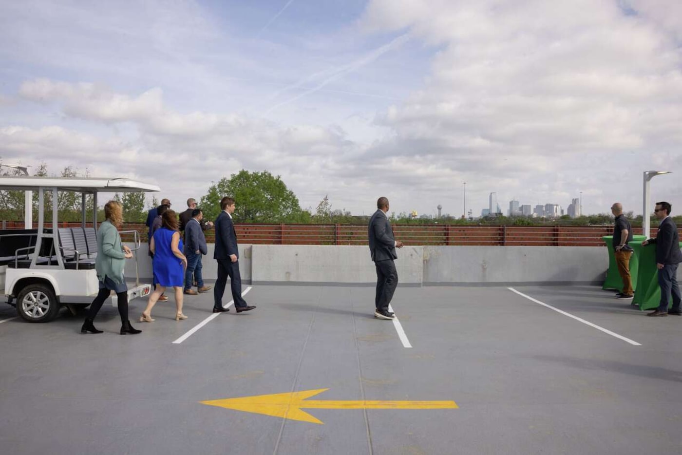 People look towards downtown on the top level of the Dallas Zoo’s new guest parking garage...