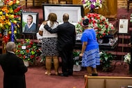Mourners console each other during the public viewing before the funeral of Botham Shem Jean...
