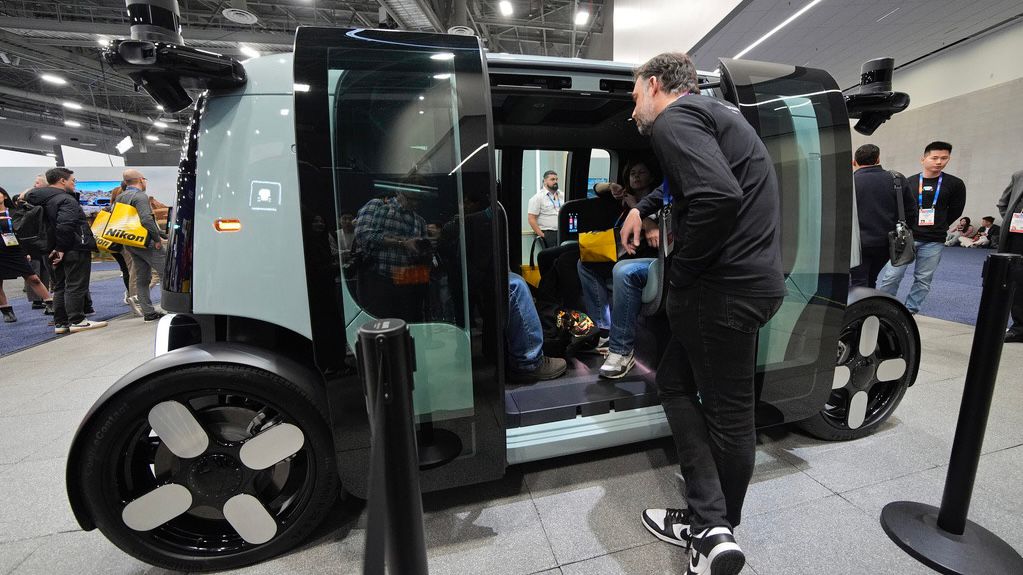 People view a Zoox self-driving vehicle at the Zoox booth during the CES tech show Tuesday, Jan. 7, 2025, in Las Vegas. (AP Photo/John Locher)