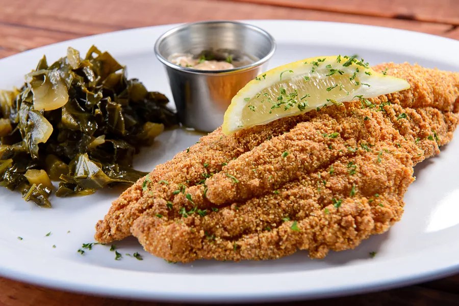 an elegant plate of fried catfish and greens