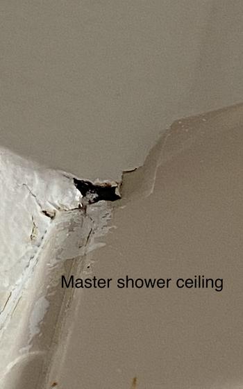 A broken part of the ceiling in the shower