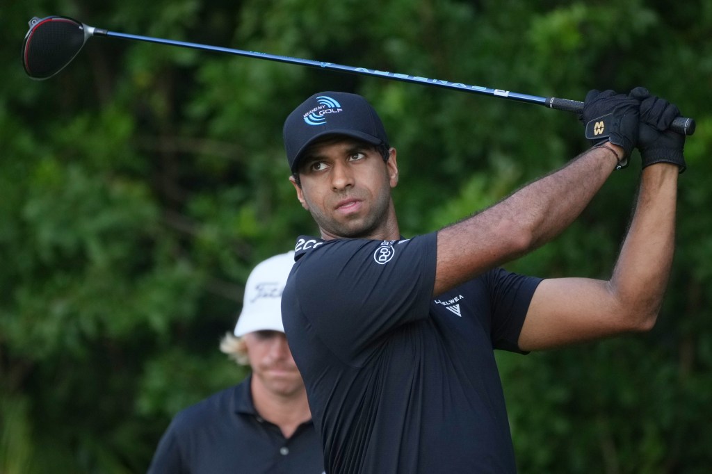 Golfer Aaron Rai hits a golf ball.