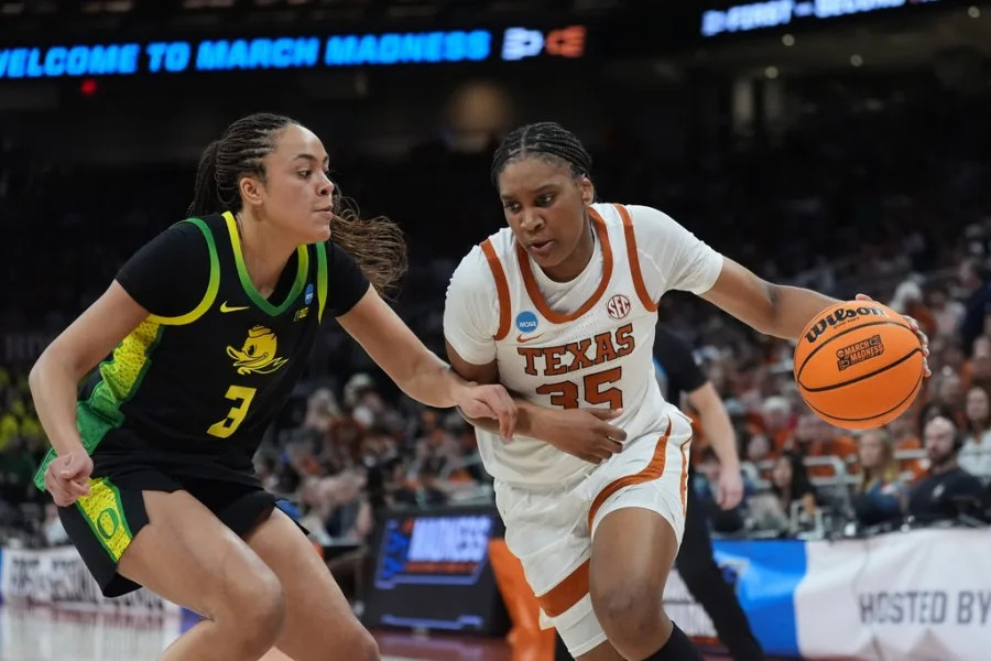 Texas forward Madison Booker (35) drives against Oregon guard Sofia Bell (3) during the second half in the second round of the NCAA college basketball tournament, Sunday, March 22, 2026, in Austin, Texas. (AP Photo/Eric Gay)