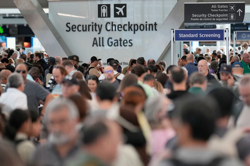 Throngs of travelers filled parts of Houston's George Bush Intercontinental Airport on Wednesday while waiting for TSA screening.