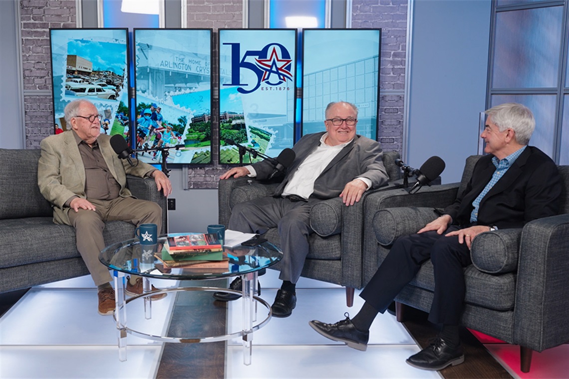 Michael Morris, Director of Transportation for the North Central Texas Council of Governments, smiles at Victor Vandergriff, Executive Director of the Tarrant Regional Transportation Coalition, while local historian OK Carter speaks.