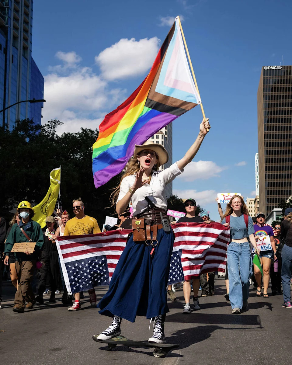 Melody Tremallo leads thousands of protesters through downtown Austin for the No Kings rally, Oct. 18, 2025. The rally against President Donald Trump and his policies included speakers, a march from the Texas State Capitol to Auditorium Shores and live music and occurred in conjunction with others across the country. (Sara Diggins/Austin American-Statesman)