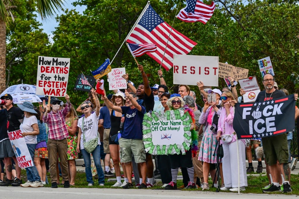 Protesters hold signs and flags near US President Donald Trump’s Mar-a-Lago resort during the “No Kings” national day of protest. AFP via Getty Images