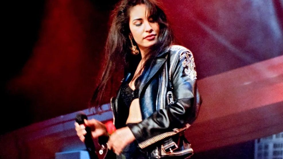 Onstage in Texas, Selena commands the crowd in a custom-designed performance outfit, blending movement, glamour, and unmistakable star power.