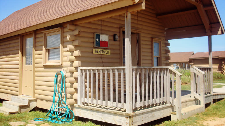 A timber vacation cabin with a front porch at Quintana Beach County Park.