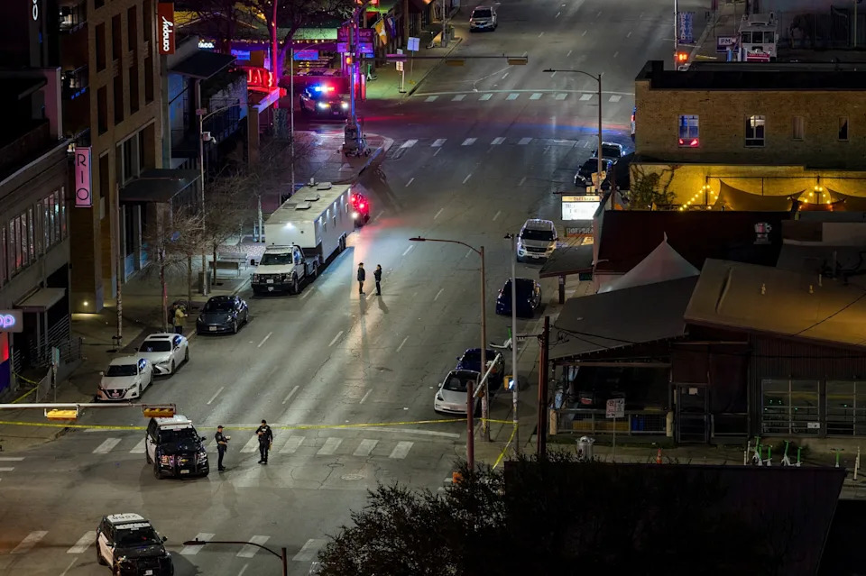 Brandon Bell/Getty Images - PHOTO: In an aerial view, law enforcement patrol an intersection near Buford's bar in downtown Austin, Texas, March 01, 2026, after a mass shooting left three people, including the alleged gunman, dead and 14 others injured