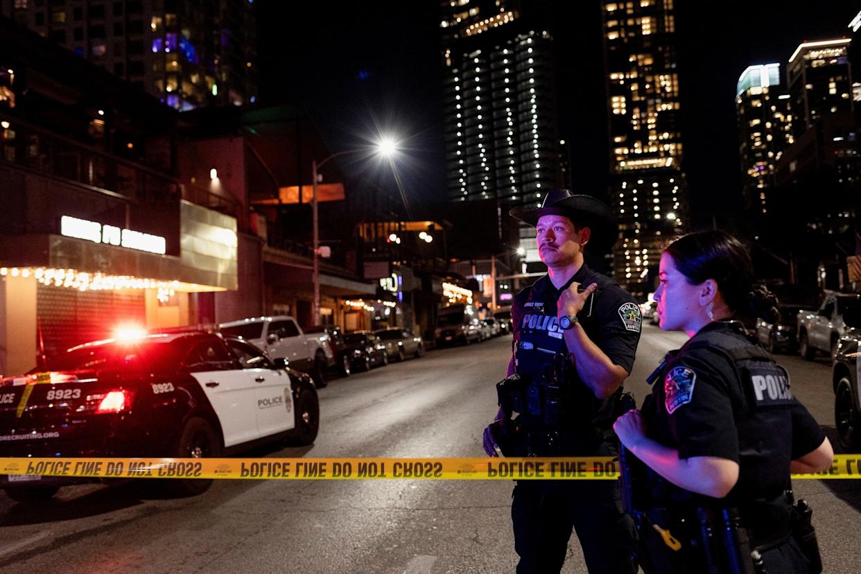 Nuri Vallbona/Reuters - PHOTO: Austin police officers work at the scene after a deadly mass shooting outside Buford's, a popular roadhouse-style bar in Austin, Texas, U.S. March 1, 2026.
