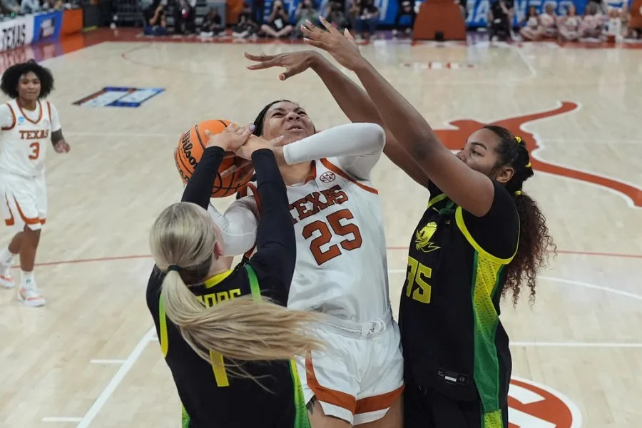 Texas forward Breya Cunningham (25) drives to the basket against Oregon forward Mia Jacobs (1) and forward Ehis Etute (35) during the first half in the second round of the NCAA college basketball tournament, Sunday, March 22, 2026, in Austin, Texas. (AP Photo/Eric Gay)