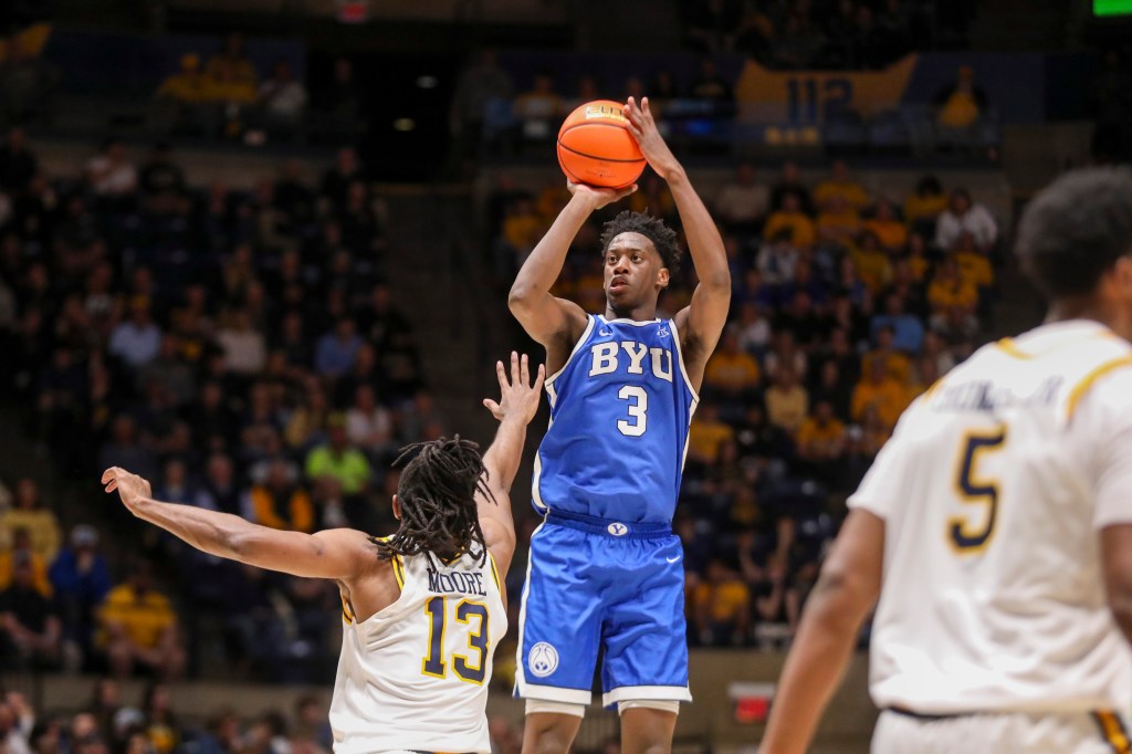 BYU Cougars forward AJ Dybantsa (3) shoots a three-point shot over West Virginia Mountaineers guard Chance Moore (13).