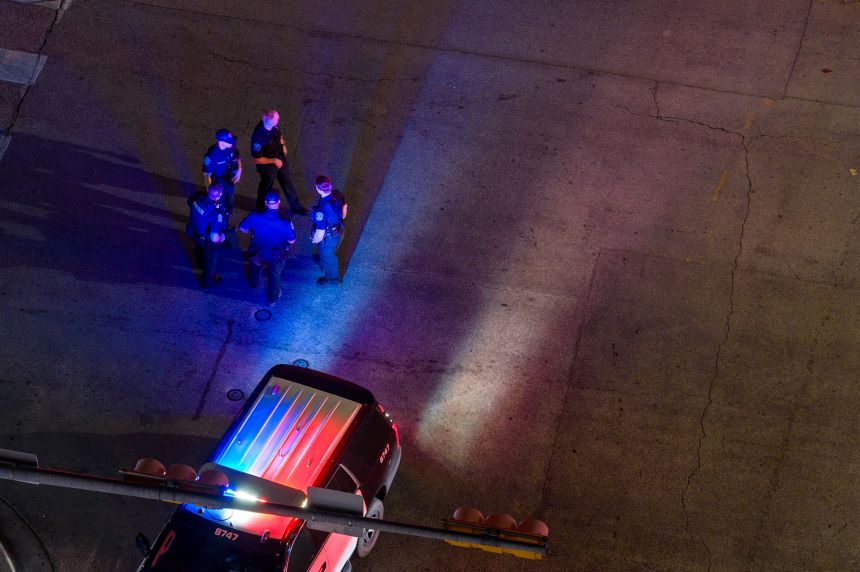 In an aerial view, law enforcement patrol an intersection near Buford's bar on Sunday in Austin, Texas.