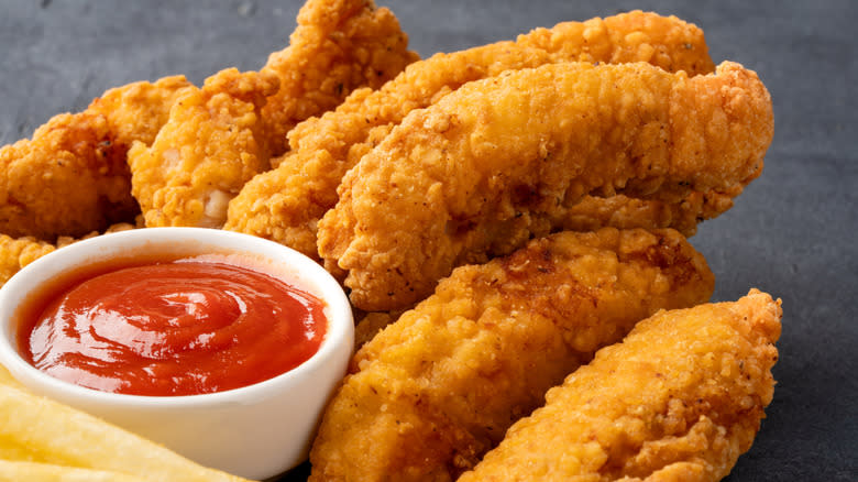 fried chicken tenders with side of ketchup