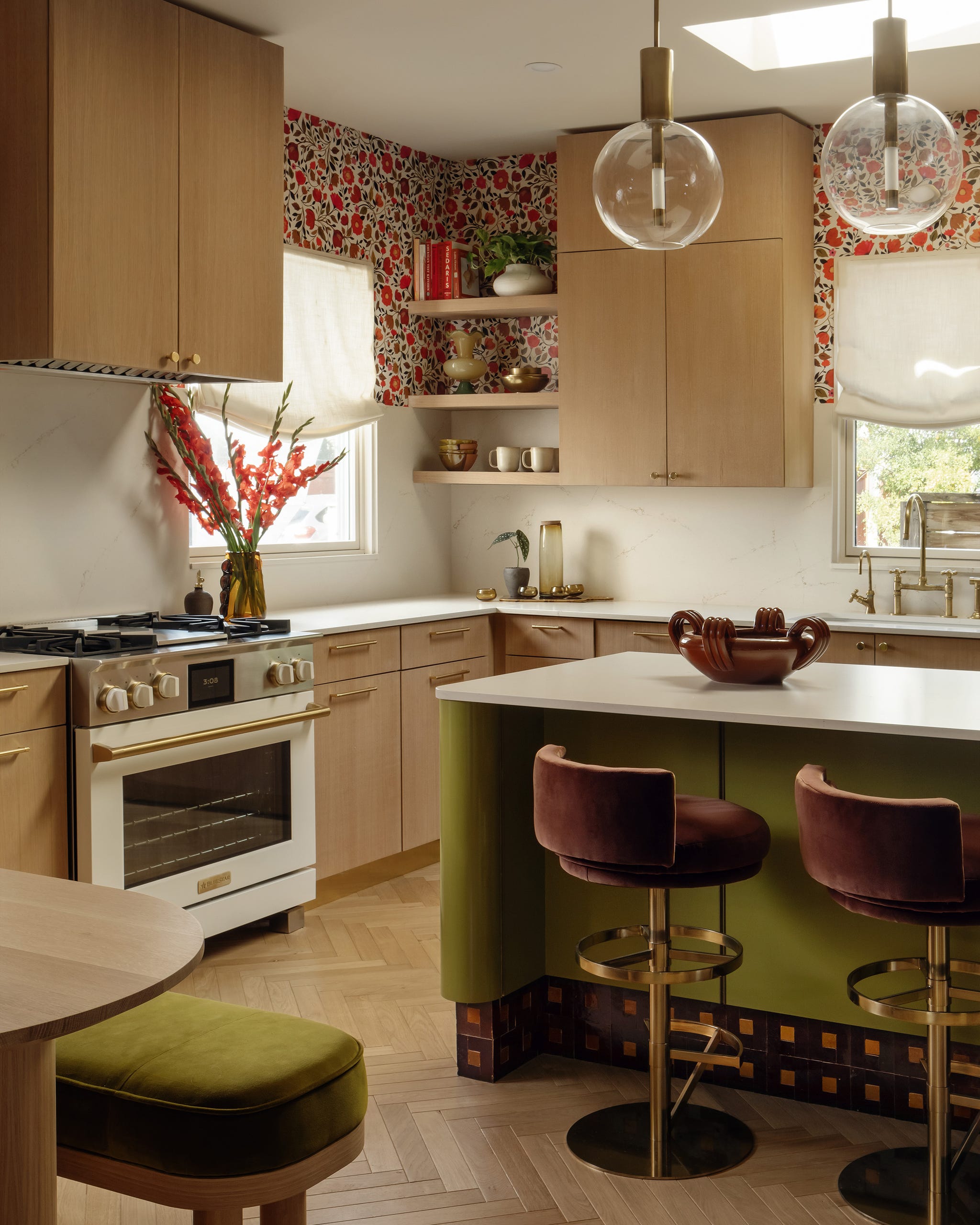 Modern kitchen with floral wallpaper and stylish furnishings.