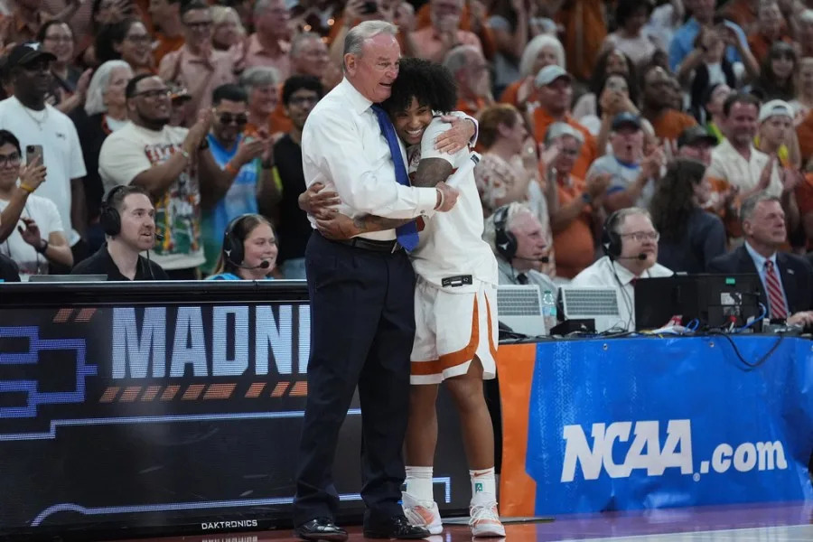 Texas guard Rori Harmon (3) celebrates with head coach Vic Schaefer during the second half in the second round of the NCAA college basketball tournament against Oregon, Sunday, March 22, 2026, in Austin, Texas. (AP Photo/Eric Gay)
