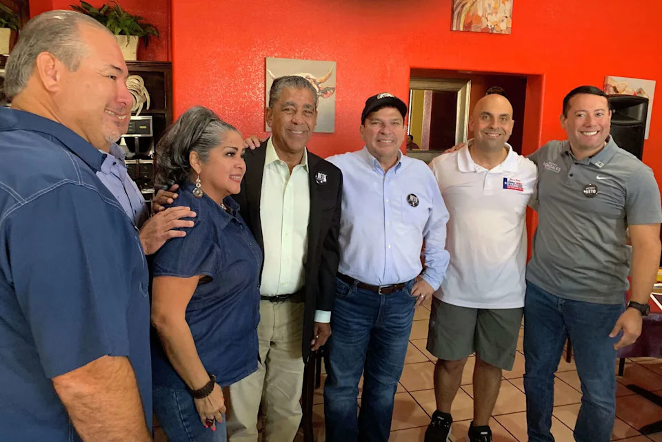 U.S. Rep. Vicente Gonzalez (third from right wearing cap) of Texas mingles with Democrats at El Dorado Restaurant in Weslaco in South Texas. To his right is U.S. Rep. Adriano Espaillat of New York. (Gromer Jeffers Jr./TNS)