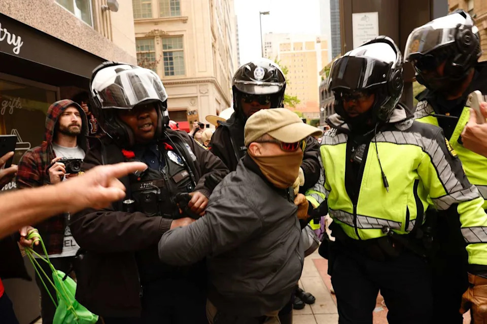Dallas police detained a man at the planned No Kings protest in downtown Dallas after an altercation with marchers on March 28, 2026. (Juan Figueroa/Staff Photographer)