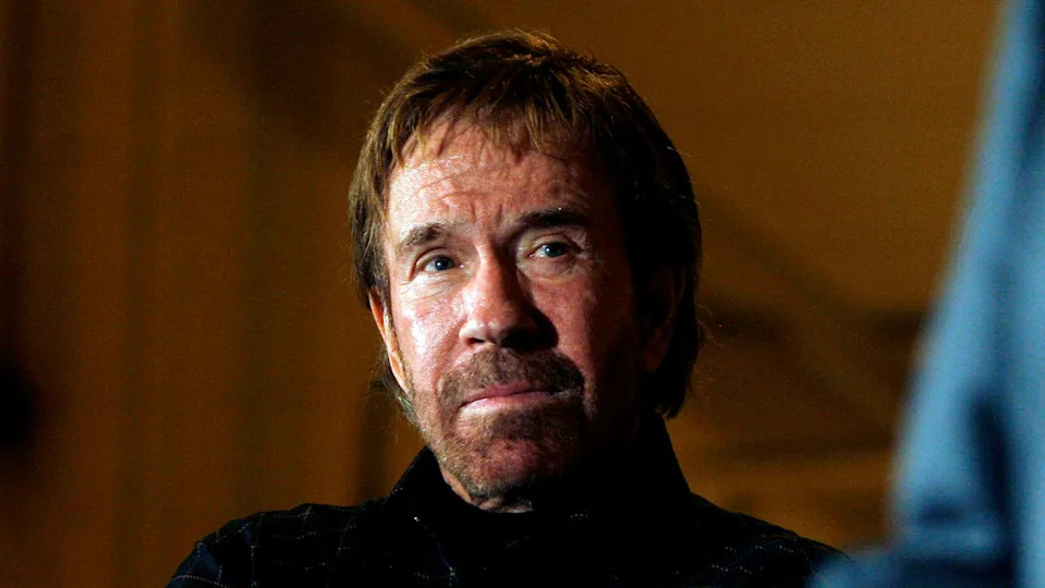 Actor Chuck Norris watches Republican presidential candidate and former Arkansas Gov. Mike Huckabee speak during a campaign stop at the Myrtle Beach Airport on Jan. 17, 2008, in Myrtle Beach, South Carolina.