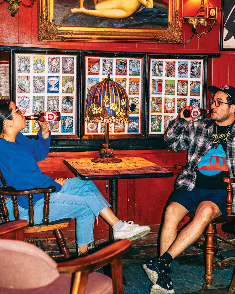 photo of two people drinking beer