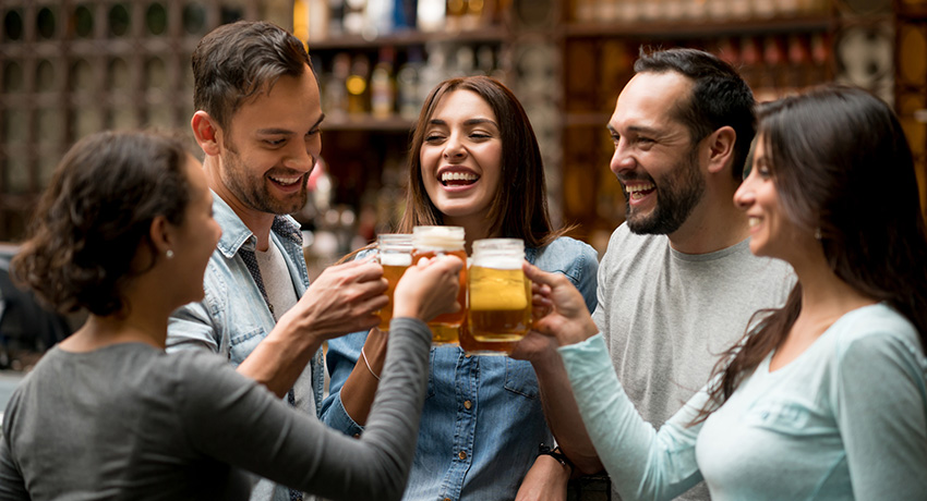 Happy group of friends making a toast at a restaurant