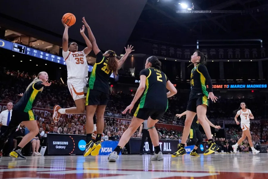 Texas forward Madison Booker (35) drives to the basket against Oregon forward Ehis Etute (35) during the second half in the second round of the NCAA college basketball tournament, Sunday, March 22, 2026, in Austin, Texas. (AP Photo/Eric Gay)