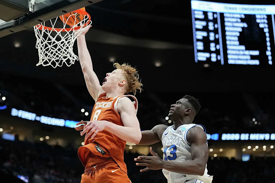 Texas post Matas Vokietaitis lays in a basket while being guarded by Keba Keita of the BYU Cougars during the first half in the first round of the 2026 NCAA Men's Basketball Tournament at Moda Center on March 19, 2026, in Portland, Oregon. (Photo by Soobum Im/Getty Images) (Soobum Im/Getty Images)