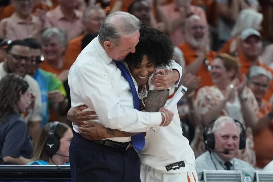 Texas guard Rori Harmon (3) celebrates with head coach Vic Schaefer during the second half in the second round of the NCAA college basketball tournament against Oregon, Sunday, March 22, 2026, in Austin, Texas. (AP Photo/Eric Gay)