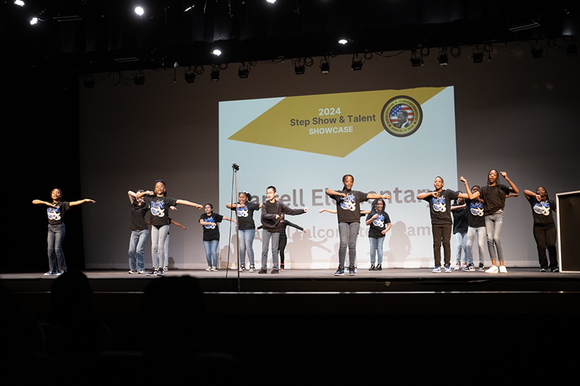 Children step dancing on stage. 
