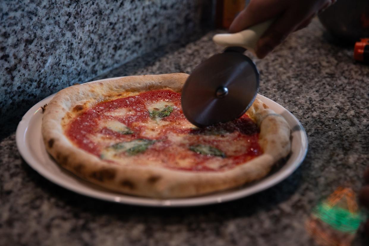A chef slices a Margherita pizza at Odi's Pizzeria & Restaurant in Corpus Christi on Jan. 9.