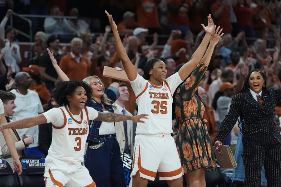Texas guard Rori Harmon (3) and forward Madison Booker (35) celebrate their win over Oregon in the second round of the NCAA college basketball tournament, Sunday, March 22, 2026, in Austin, Texas. (AP Photo/Eric Gay)
